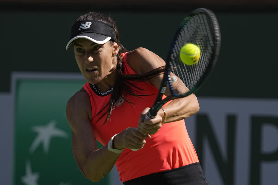 Sorana Cirstea, of Romania, returns a shot to Iga Swiatek, of Poland, at the BNP Paribas Open tennis tournament Thursday, March 16, 2023, in Indian Wells, Calif. (AP Photo/Mark J. Terrill)