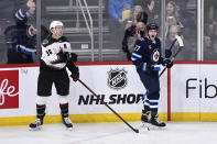 Winnipeg Jets' Nikolaj Ehlers (27) celebrates his goal against the Arizona Coyotes in front of Christian Fischer (36) during the first period of an NHL hockey game, Tuesday, March 21, 2023 in Winnipeg, Manitoba. (Fred Greenslade/The Canadian Press via AP)