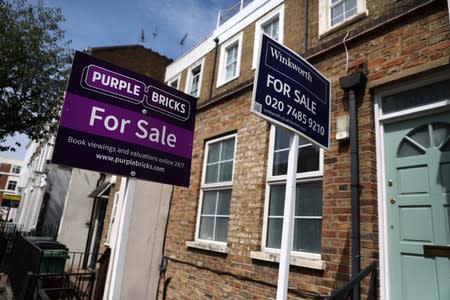 Estate agent boards are displayed outside a property in London