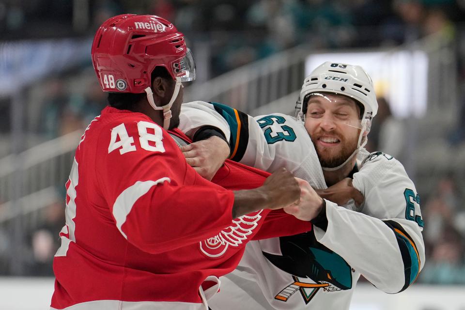 Detroit Red Wings right wing Givani Smith (48) fights with San Jose Sharks left wing Jeffrey Viel (63) during the first period of an NHL hockey game Tuesday, Jan. 11, 2022, in San Jose, Calif.