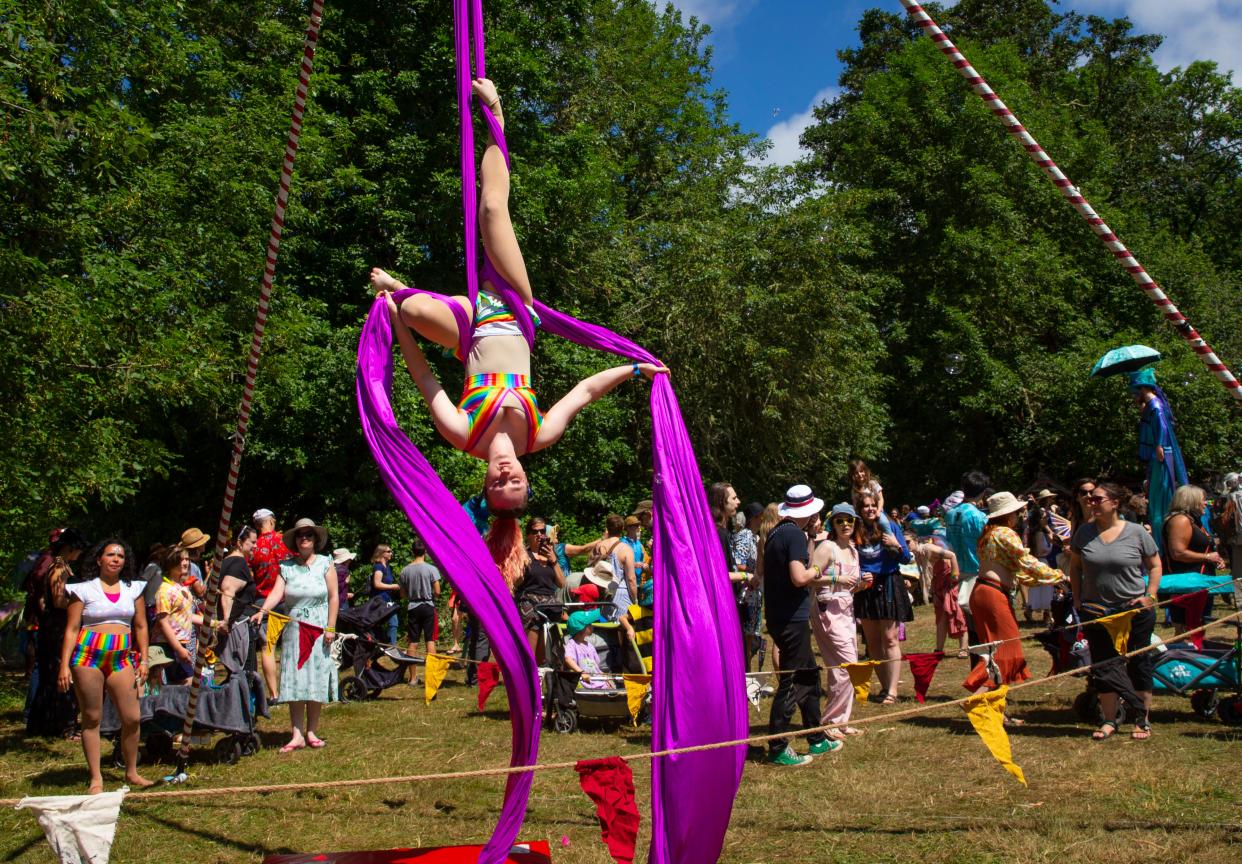 A performer with Revelers Aerial Works entertains visitors to the Oregon Country Fair in 2022.