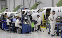 This July 30, 2019 shows several HondaJet aircraft in production at the Honda Aircraft Co. headquarters in Greensboro, N.C. Nearly four years after delivering its first jet, Honda is facing decisions as the company better known for cars and lawnmowers considers whether to sink billions more into its decades-in-the-making aircraft division. (AP Photo/Gerry Broome)