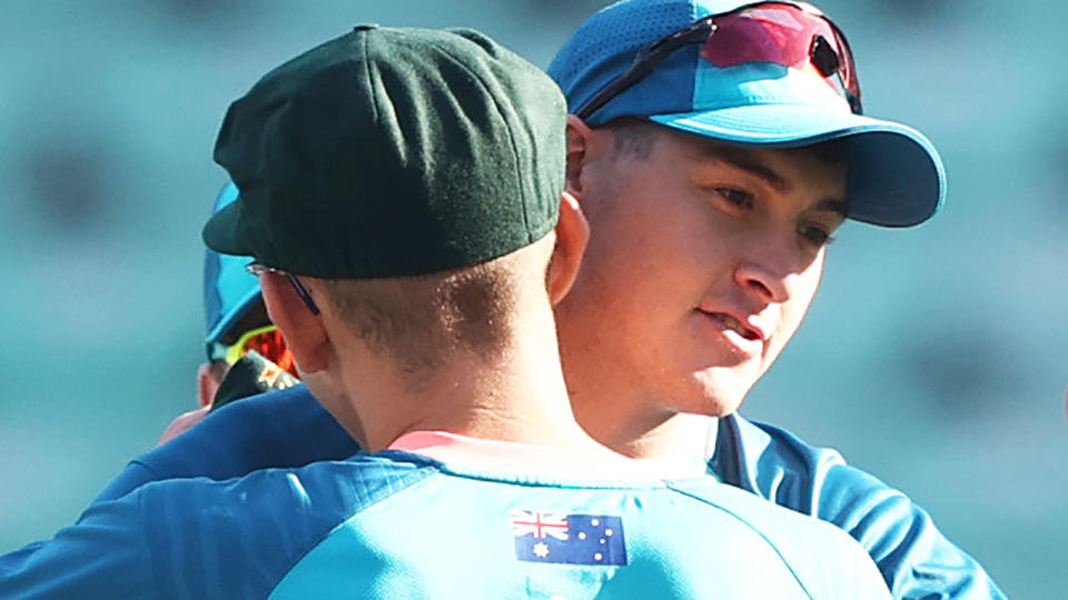 Matt Renshaw embraces an Australian teammate during warmup for the first Test against India.