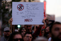 <p>A demonstrator holds signs during a rally in response to the Charlottesville, Virginia car attack on counter-protesters after the “Unite the Right” rally organised by white nationalists, in Oakland, California, U.S., August 12, 2017. (Stephen Lam/Reuters) </p>