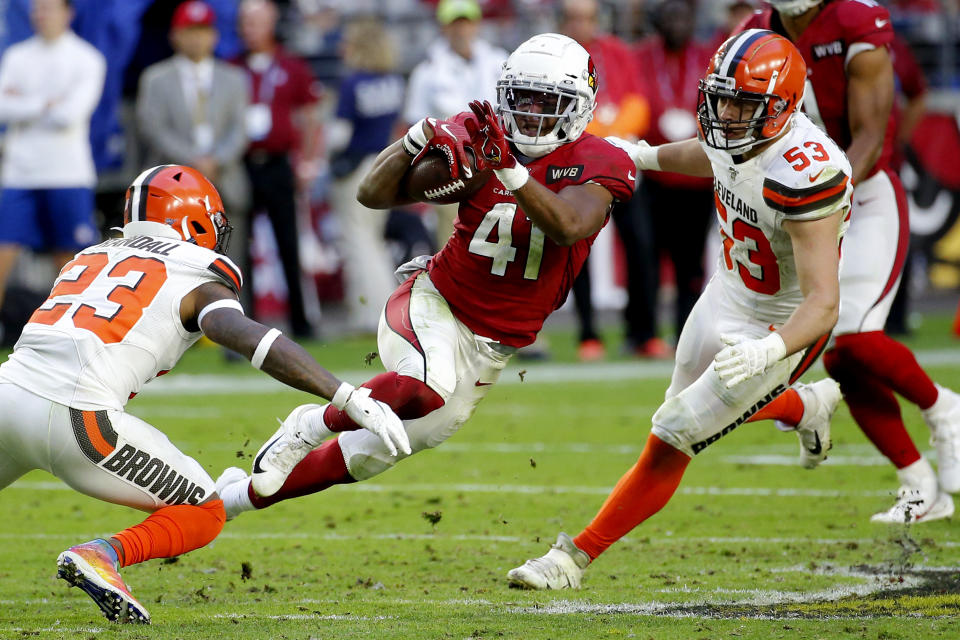Arizona Cardinals running back Kenyan Drake (41) tries to elude Cleveland Browns free safety Damarious Randall (23) and middle linebacker Joe Schobert (53) during the second half of an NFL football game, Sunday, Dec. 15, 2019, in Glendale, Ariz. (AP Photo/Rick Scuteri)
