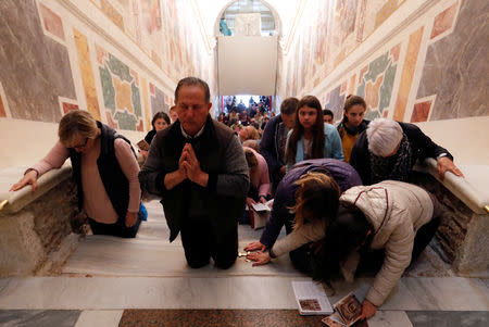 Worshippers pray on the Holy Stairs in Rome, Italy April 16 2019. REUTERS/Remo Casilli