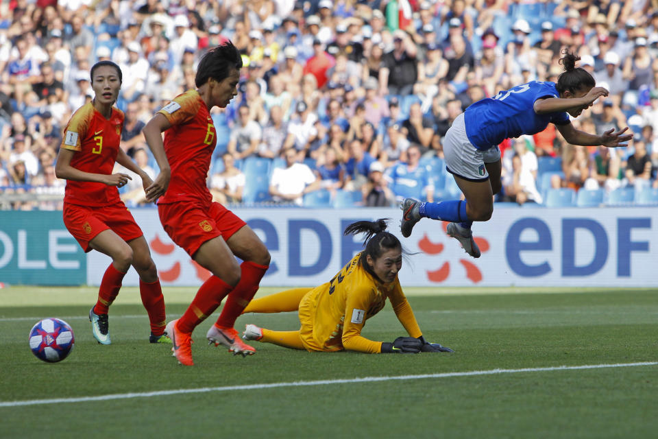 Italy's Elisa Bartoli, right, jumps over China goalkeeper Peng Shimeng, second right, just before Italy's Valentina Giacinti scored the opening goal during the Women's World Cup round of 16 soccer match between Italy and China at Stade de la Mosson in Montpellier, France, Tuesday, June 25, 2019. (AP Photo/Claude Paris)