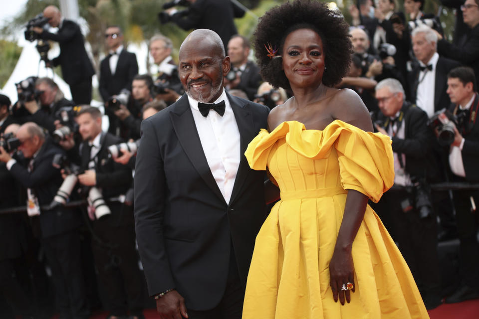 FILE - Julius Tennon, left, and Viola Davis pose for photographers upon arrival at the premiere of the film 'Top Gun: Maverick' at the 75th international film festival, Cannes, southern France, Wednesday, May 18, 2022. Star power has been out in force at the 75th Cannes Film Festival. After a 2021 edition muted by the pandemic, this year's French Riviera spectacular has again seen throngs of onlookers screaming out "Tom!" "Julia!" and "Viola!" The wattage on display on Cannes' red carpet has been brighter this year thanks the presence of stars like Tom Cruise, Julia Roberts, Viola Davis, Anne Hathaway, Idris Elba and others. But as the first half of the French Riviera spectacular has shown, stardom in Cannes is global. Just as much as cameras have focused on Hollywood stars, they've been trained on the likes of India's Aishwarya Rai and South Korea's Lee Jung-jae. (Photo by Vianney Le Caer/Invision/AP, File)