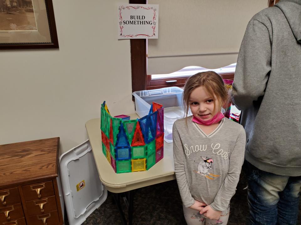 An MLK Day participant shows off her craft work.