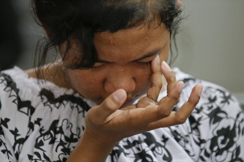 A Christian wipes tears from her eyes as she attends church at the earthquake and tsunami-hit town of Palu, Central Sulawesi, Indonesia Sunday, Oct. 7, 2018. Christians dressed in their tidiest clothes flocked to Sunday sermons in the earthquake and tsunami damaged Indonesian city of Palu, hoping for answers to the double tragedy that inflicted deep trauma on their community. (AP Photo/Aaron Favila)