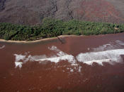 In this Nov. 23, 2003, photo provided by Ku'ulei Rodgers, muddy floodwater flows over a nearshore coral reef off the Hawaiian Island of Lanai after a heavy rainstorm. Flooding in March 2021, in Hawaii caused widespread and obvious damage. But extreme regional rain events that are predicted to become more common with global warming do not only wreak havoc on land, the runoff from these increasingly severe storms is also threatening Hawaii's coral reefs. (Ku'ulei Rodgers/University of Hawaii via AP)