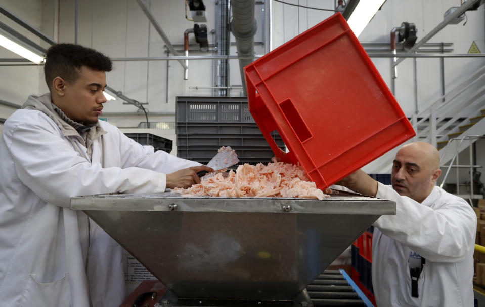 FILE - In this Thursday, Jan. 17, 2019 file photo, Shane Bedasee, left, and Ozzie Ibrahim, right, work preparing soap at the Clarity-The Soap Co. premises in London. The U.K. election result means Britain's departure from the European Union will almost certainly happen - after multiple delays - on Jan. 31, as scheduled. But for companies that have had to plan for all sorts of potentially chaotic outcomes to Brexit, even just a little clarity is a breath of fresh air. “The idea that the situation with Brexit is going to be resolved is good for business,” said Andy Zneimer, who handles communications for a small soap business in east London called Clarity-The Soap Co. (AP Photo/Kirsty Wigglesworth, file)
