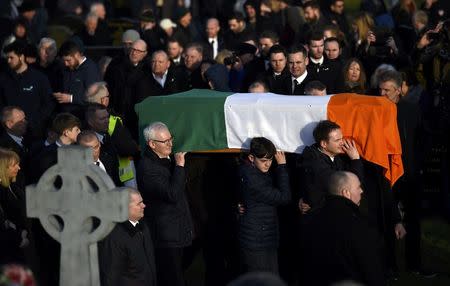 The coffin of Martin McGuinness is carried through crowded streets during his funeral in Londonderry, Northern Ireland, March 23, 2017. REUTERS/Clodagh Kilcoyne