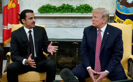 U.S. President Donald Trump meets Qatar's Emir Sheikh Tamim bin Hamad al-Thani in the Oval Office at the White House in Washington, DC, U.S., April 10, 2018. REUTERS/Kevin Lamarque/Files