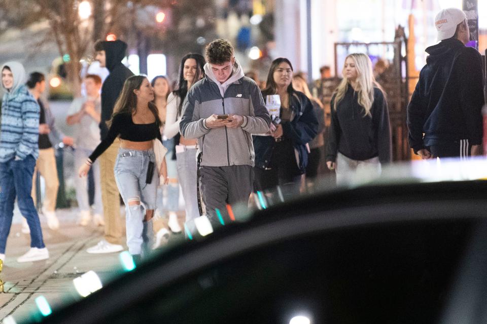 People walk down the Cumberland Avenue Strip on Jan. 29, 2021. The closer college students get to legal drinking age, the more likely they are to develop an alcohol use disorder.