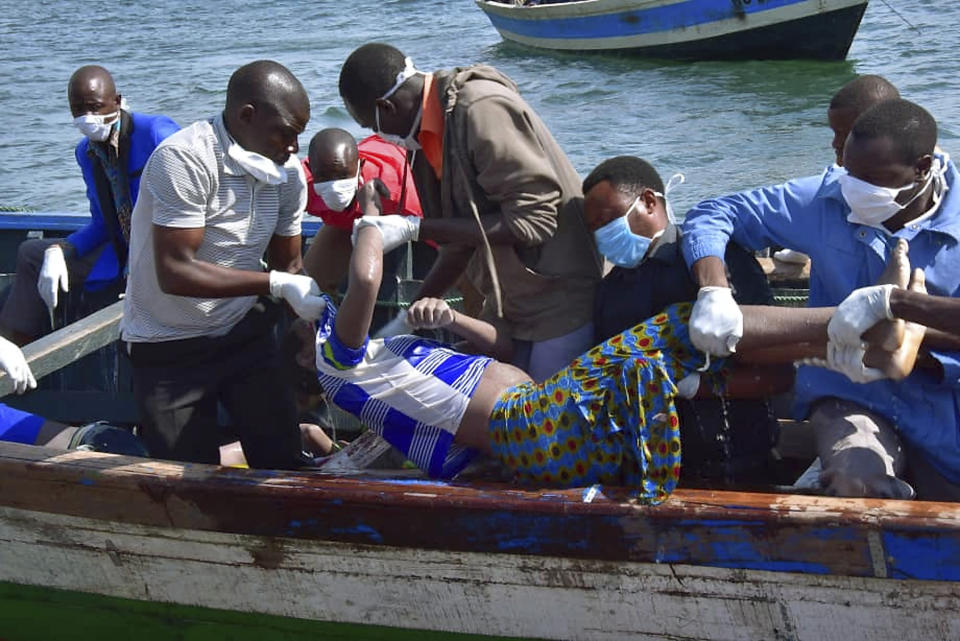 Rescuers retrieve a body from the water near Ukara Island in Lake Victoria, Tanzania Friday, Sept. 21, 2018. The death toll rose above 100 after the passenger ferry MV Nyerere capsized on Lake Victoria, Tanzania state radio reported Friday, while a second day of rescue efforts raced the setting sun. (AP Photo)