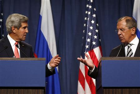 U.S. Secretary of State John Kerry (L) and Russian Foreign Minister Sergei Lavrov gesture, following meetings regarding Syria, at a news conference in Geneva September 14, 2013. REUTERS/Larry Downing