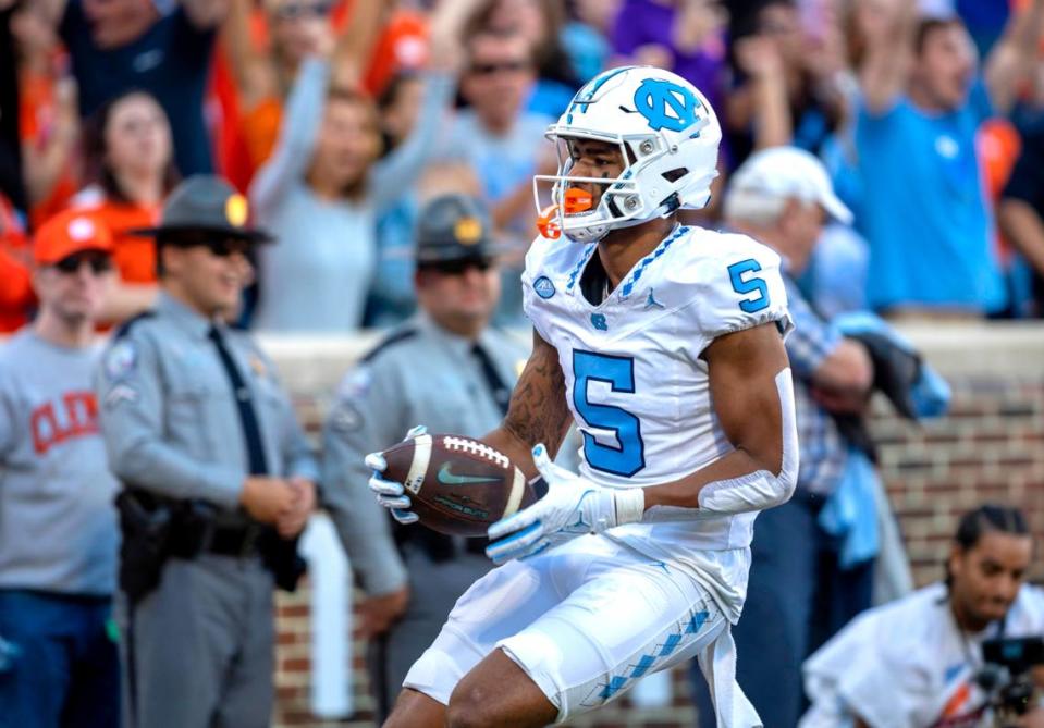 North Carolina’s J.J. Jones (5) scores on a 33-yard pass reception from quarterback Drake Maye to give the Tar Heels a 7-0 lead over Clemson in the first quarter on Saturday, November 18, 2023 at Memorial Stadium in Clemson, S.C.