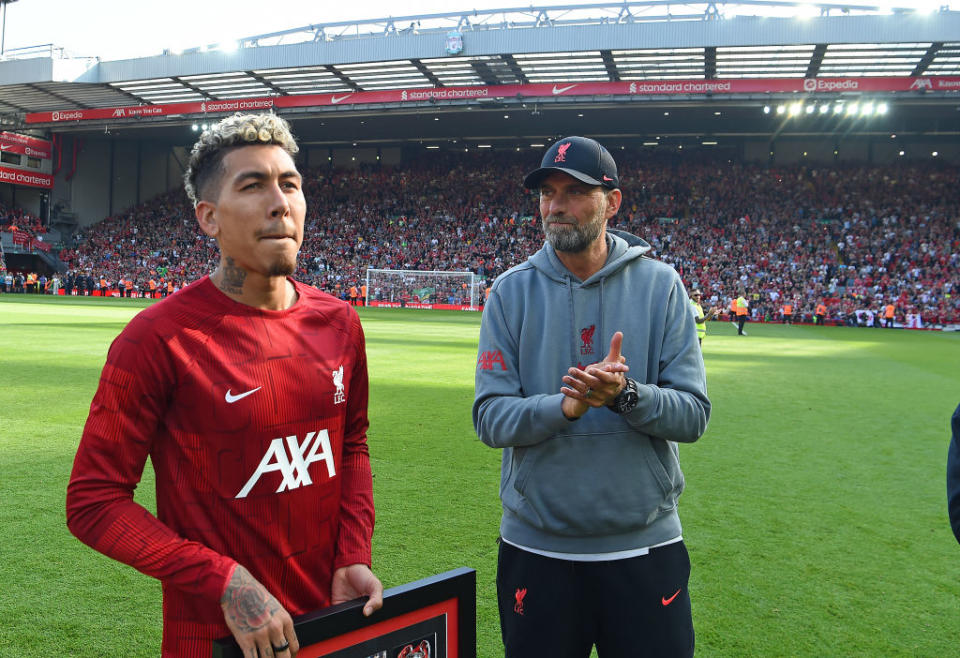 Jurgen Klopp manager of Liverpool with Roberto Firmino of Liverpool at the end of the Premier League match between Liverpool FC and Aston Villa at Anfield on May 20, 2023 in Liverpool, England.