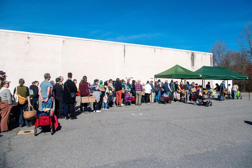 A line forms as the Bounty & Soul Community Market opens in Black Mountain, November 14, 2023.