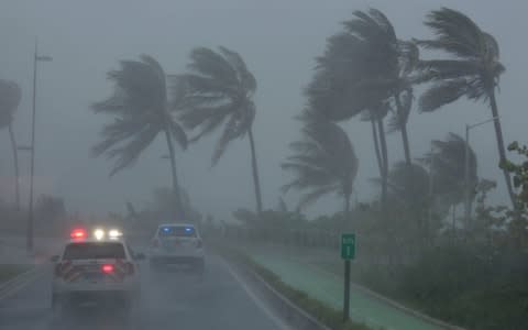 Police patrol the area as Hurricane Irma slams across islands in the northern Caribbean on Wednesday, in San Juan, Puerto Rico - Credit: REUTERS/Alvin Baez