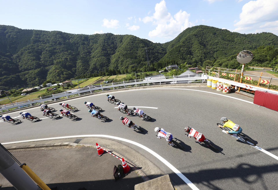 <p>Cyclists compete in the women's cycling road race at the 2020 Summer Olympics, Sunday, July 25, 2021, in Oyama, Japan. (Michael Steele/Pool Photo via AP)</p> 