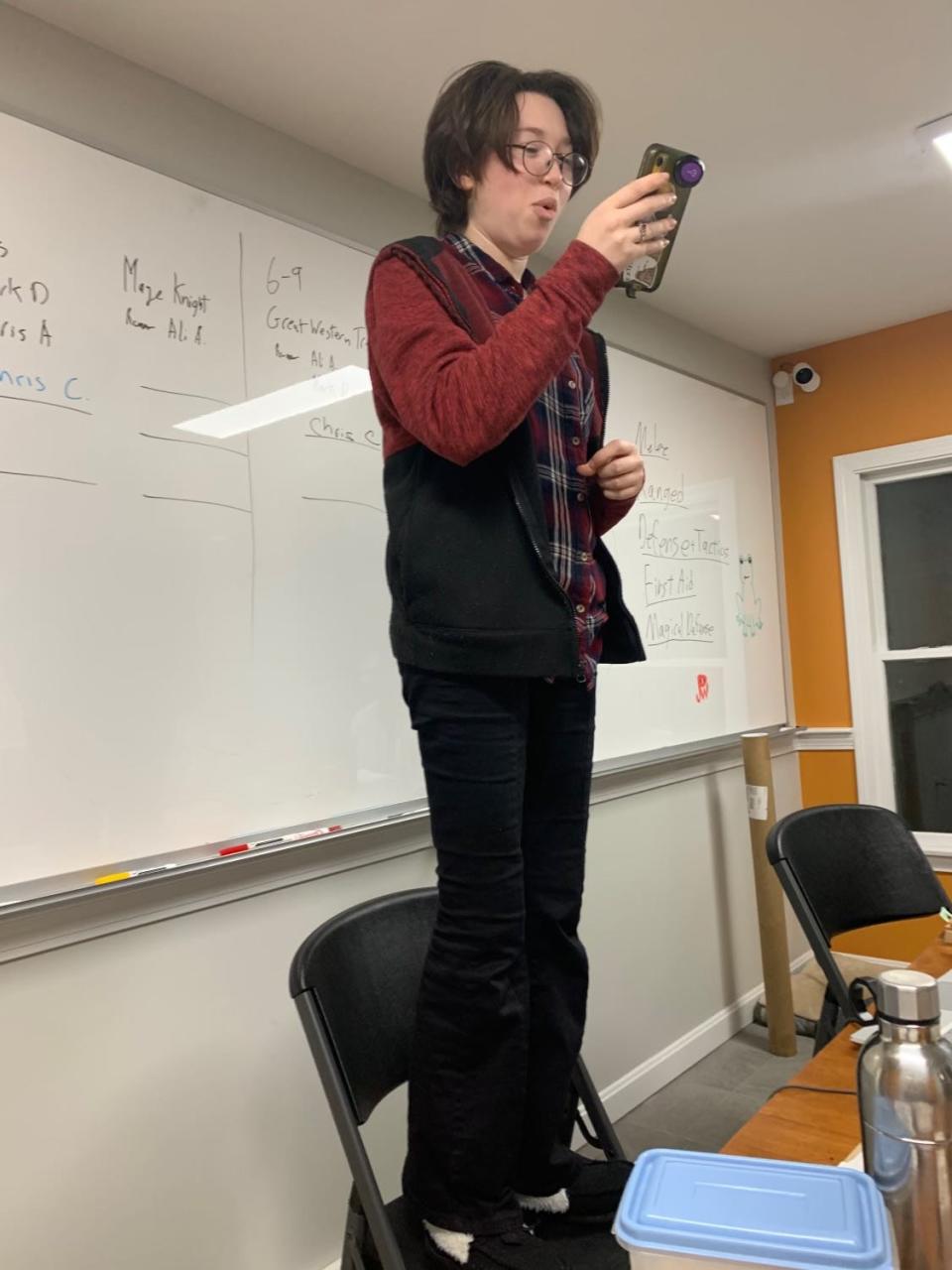 In an impromptu call to arms, Lyndsey Rotman stood on a chair and recited the St. Crispin's Day speech at Vanguard Tabletop Gaming in Hyannis.