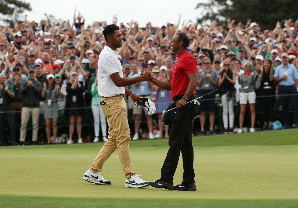 Golf - Masters - Augusta National Golf Club - Augusta, Georgia, U.S. - April 14, 2019. Tiger Woods of the U.S. shakes hands with Tony Finau of the U.S. as he celebrates on the 18th hole to win the 2019 Masters. REUTERS/Jonathan Ernst