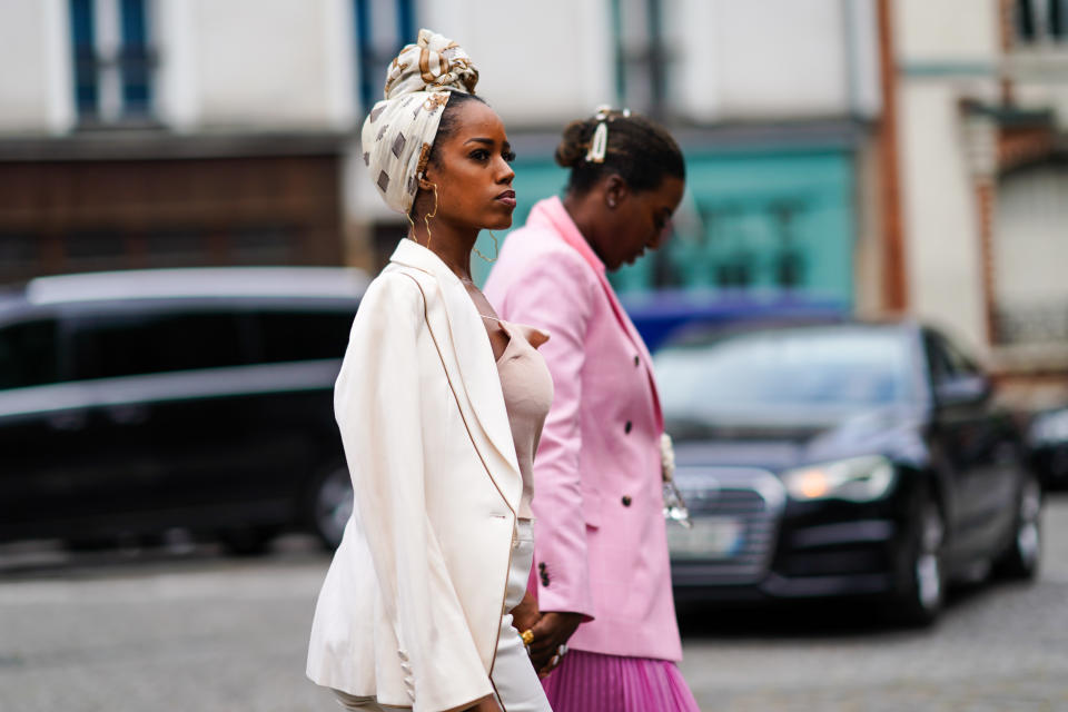 PARIS, FRANCE - JUNE 22: A guest wears a hair scarf, large earrings representing a map, an old-pink strappy top, a cream-color jacket, outside Hermes, during Paris Fashion Week - Menswear Spring/Summer 2020, on June 22, 2019 in Paris, France. (Photo by Edward Berthelot/Getty Images)