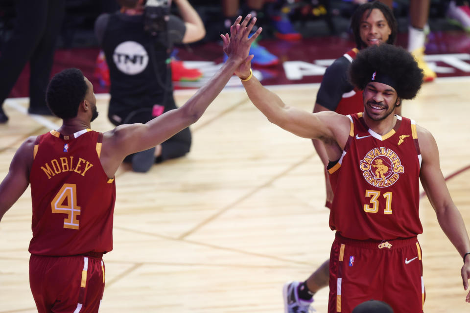 Cleveland Cavaliers' Jarrett Allen (31) celebrates with teammate Evan Mobley after making a shot during the skills challenge competition, part of NBA All-Star basketball game weekend, Saturday, Feb. 19, 2022, in Cleveland. (AP Photo/Ron Schwane)