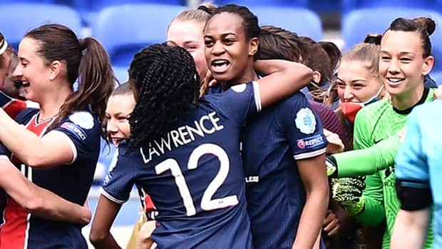 Toronto's Ashley Lawrence celebrates with a teammate after Paris Saint-Germain upset five-time defending champion Lyon 2-1 in UEFA Women's Champions League quarter-final play on Sunday. (Jeff Pachoud/AFP via Getty Images - image credit)