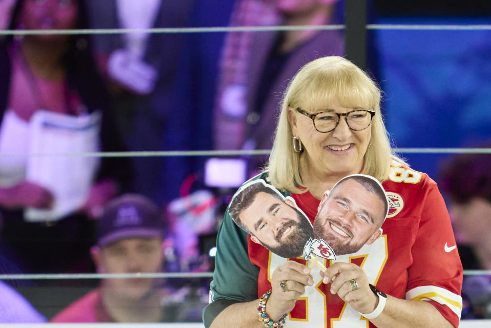 Donna Kelce holds up photos of her sons, Jason Kelce of the Philadelphia Eagles and Travis Kelce of the Kansas City Chiefs. (Photo by Cooper Neill/Getty Images)