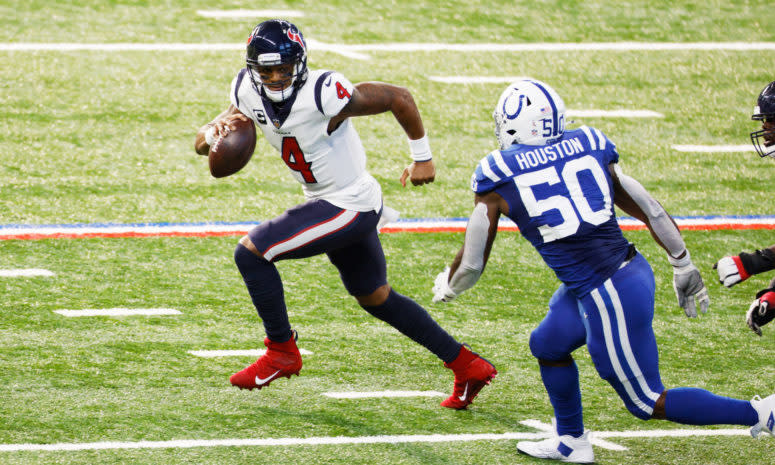 Houston Texans quarterback Deshaun Watson runs away from a defender.