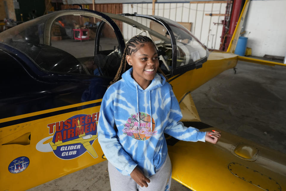 Lauryn Billingsley, 16, is photographed next to a Tuskegee Airmen glider, Thursday, Aug. 17, 2023, in Detroit. Billingsley is considering the U.S. Air Force and then a career as a commercial pilot for Delta Air Lines and is part of a program that teaches young people how to fly, while exposing them to careers in aviation and as pilots...areas people of color traditionally are underrepresented. (AP Photo/Carlos Osorio)