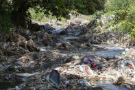 A tributary of the Nairobi River, which traverses informal settlements and industrial hubs, is seen full of garbage in Nairobi, Kenya, Wednesday, Jan. 11, 2023. As clean water runs short, one of Africa's fastest growing cities is struggling to balance the needs of creating jobs and protecting the environment, and the population of over 4 million feels the strain. (AP Photo/Khalil Senosi)