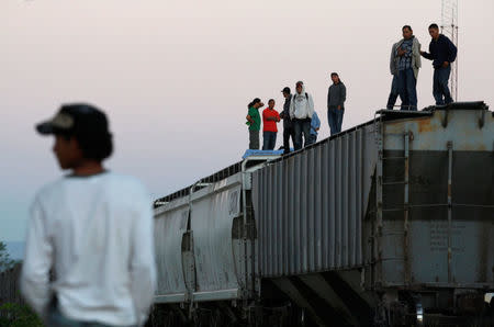 Central American migrants stand atop wagons while waiting for the freight train "La Bestia", or the Beast, to travel to north Mexico to reach and cross the U.S. border, in Arriaga in the state of Chiapas January 10, 2012. REUTERS/Jorge Luis Plata/File Photo
