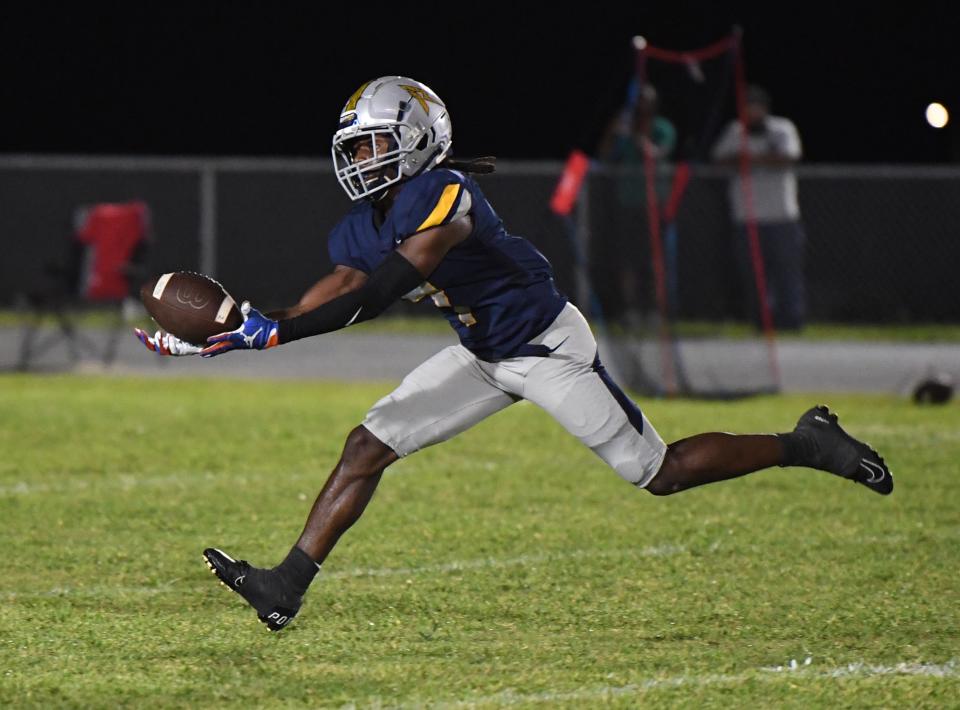 Rick Penick catches a ball from quarterback John Kustuch. The play is officially a 71-yard touchdown connection. Ridge won the game 21-0.