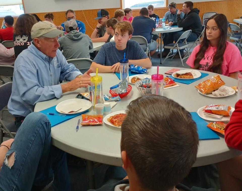 Mentor and Merchant Marine officer Greg Braunlich speaks with students during lunch at Maritime Career Day.