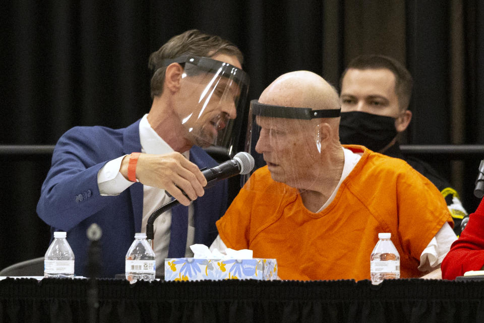 Joseph Cress, left, the public defender for Joseph James DeAngelo, charged with being the Golden State Killer, whispers to his client during a hearing in Sacramento Superior Court in Sacramento, Calif. Monday June 29, 2020. DeAngelo, 74, pleaded guilty to 13 counts of murder and multiple other charges 40 years after a sadistic series of assaults and slayings in California. Due to the large numbers of people attending, the hearing was held at a ballroom at California State University, Sacramento to allow for social distancing. (AP Photo/Rich Pedroncelli)