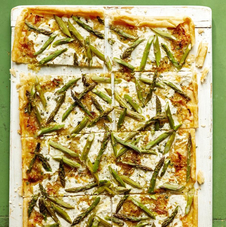 easter brunch ideas cheesy asparagus tart on white wood board