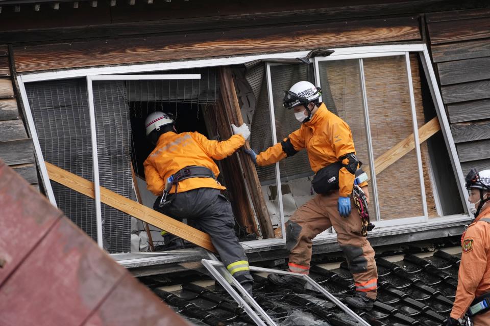 Rescue workers search a collapsed house caused by powerful earthquake in Suzu, Ishikawa Prefecture Wednesday, Jan. 3, 2024. A series of powerful earthquakes hit western Japan, damaging buildings, vehicles and boats, with officials warning people in some areas on Tuesday to stay away from their homes because of a risk of more strong quakes. (AP Photo/Hiro Komae)