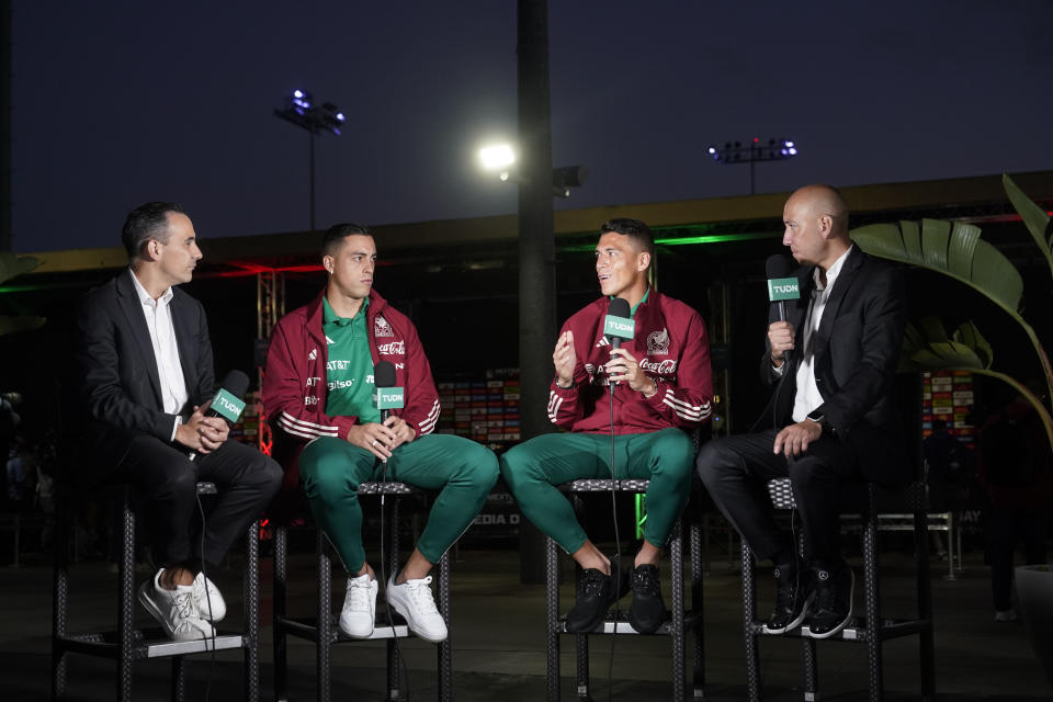 Mexico's Hector Moreno, center right, and Rogelio Funes Mori, center left, conduct an interview during the soccer team's Media Day ahead of the 2022 FIFA World Cup in Qatar Tuesday, Sept. 20, 2022, in Carson, Calif. (AP Photo/Marcio Jose Sanchez)