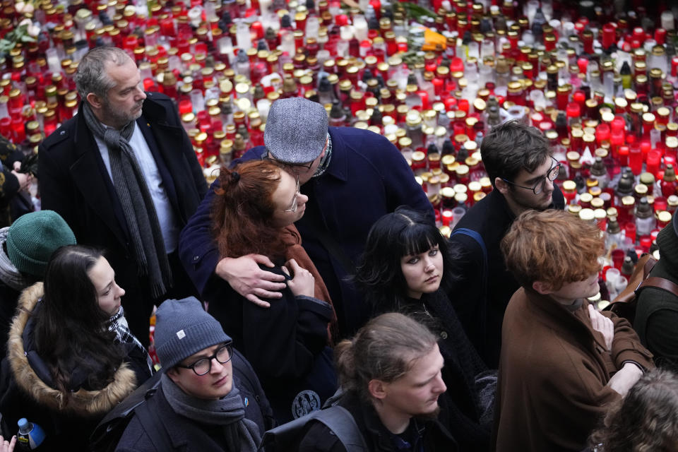 People gather in front of headquarters of Charles University in Prague, Czech Republic, Thursday, Jan. 4, 2024. Thousands of students and other Czechs marched in silence in the Czech capital on Thursday to honor the victims of the country's worst mass killing that left 14 dead on Dec. 21, 2023. (AP Photo/Petr David Josek)
