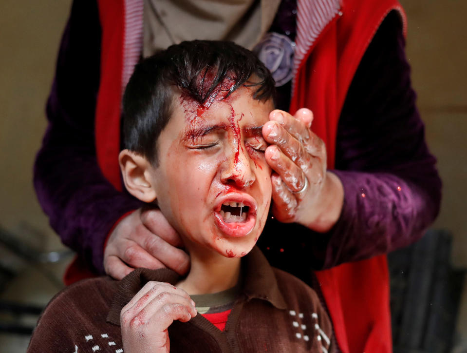 <p>The mother of a boy injured during a battle between Iraqi troops and Islamic state fighters washes his face inside a house before they were rescued by Iraqi special forces in Mosul, Iraq, Feb. 28, 2017. (Goran Tomasevic/Reuters) </p>