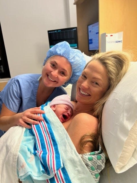 TNT NBA sideline reporter Allie LaForce holds her newborn son, Jacob Michael Smith, with her sister, Dr. AuBree LaForce. AuBree, a Cleveland Clinic Akron General family medicine resident.