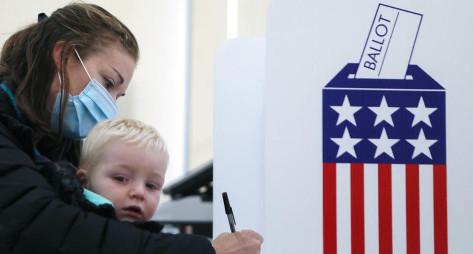 A mum pictured voting with her young son. 