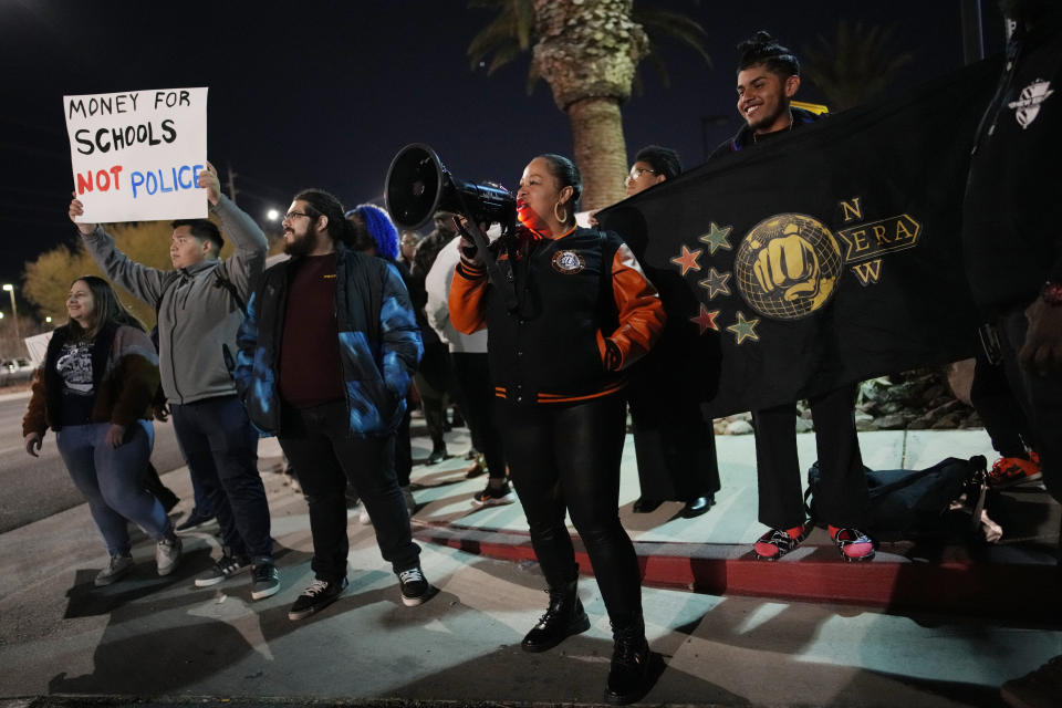 FILE - Karena Graham, center, president of New Era Las Vegas, leads a chant during a protest against police violence Friday, Feb. 17, 2023, in Las Vegas. School officials in Las Vegas have released police reports and body camera footage of a white campus police officer kneeling on a Black student who had been recording officers a year ago in a scene that was captured on cellphone video and widely shared on social media. (AP Photo/John Locher, FILE)