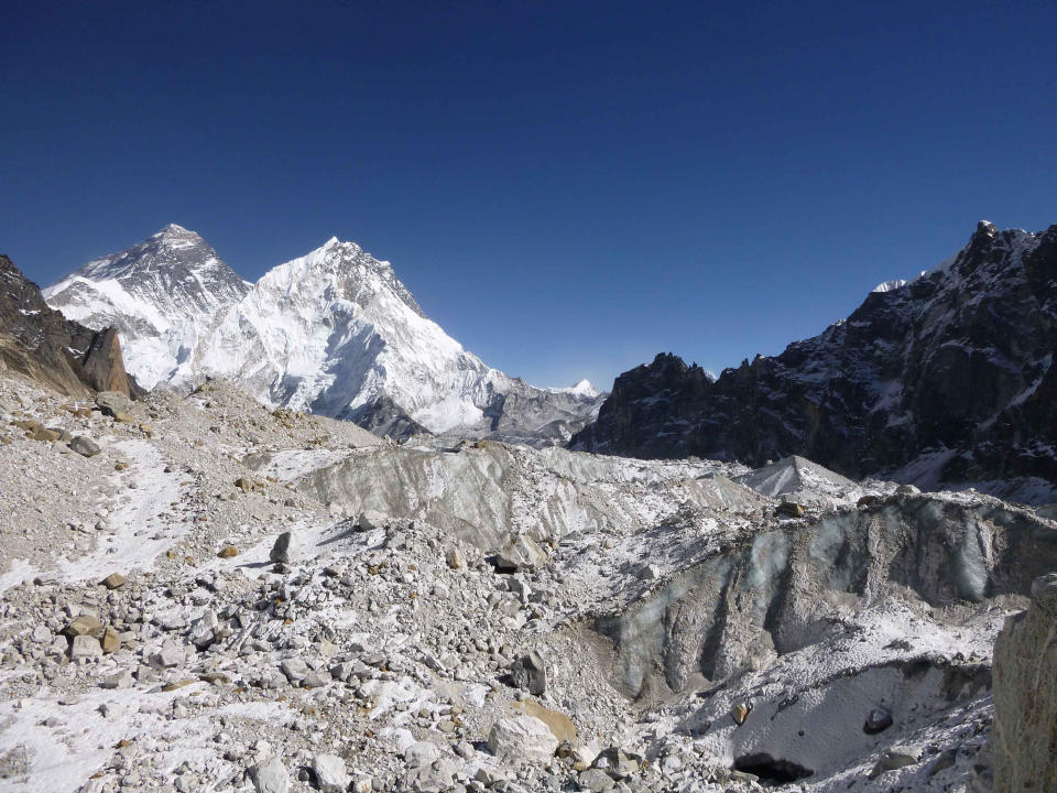 This 2014 photo provided by Joshua Maurer shows the Changri Nup Glacier in Nepal, much of it covered by rocky debris. The peak of Mt. Everest is partially obscured at background left. From 2000-2016, the Himalayan mountain range has been losing about 8.3 billion tons (7.5 billion metric tons) of ice a year, compared 4.3 billion tons (3.9 billion metric tons) a year between 1975 and 2000, according to a study published in the journal Science Advances on Wednesday, June 19, 2019. (Joshua Maurer via AP)