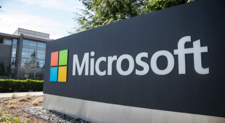 Wide angle view of a Microsoft sign at the headquarters for personal computer and cloud computing company, with office building in the background.. MSFT stock