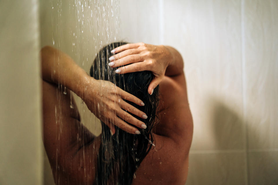 Woman rinsing her hair